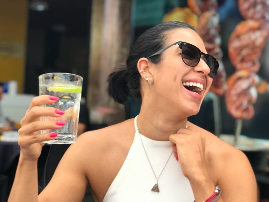 photo of a woman holding a glass of water